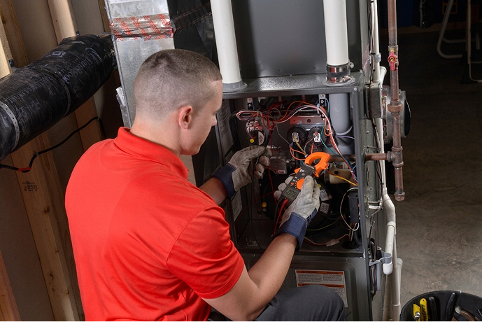 Close up of a repair technician working on a furnace